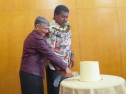 Rev Tulagi and Rev Griffiths cutting cake